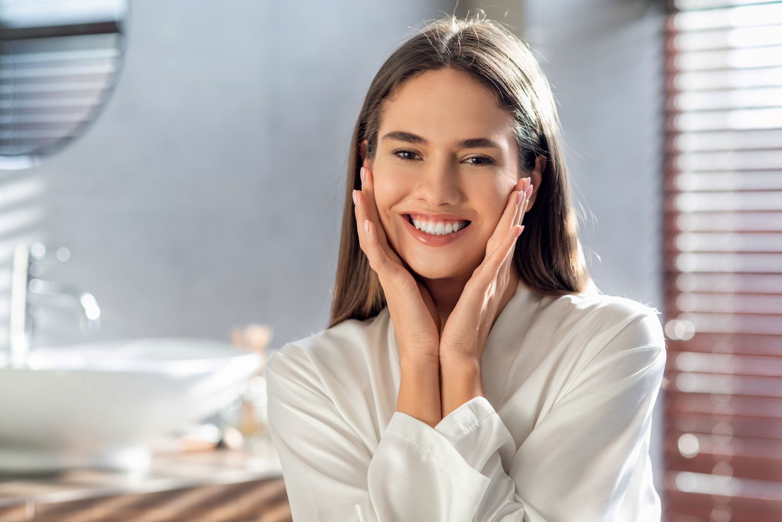 Woman smiling confidently with a bright, natural-looking smile highlighting cosmetic dentistry results